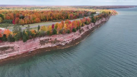Zoom In-Out Red Cliffs Vibrant Autumn Colors on Beautiful Blue Lake Stock Footage 315265693
