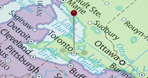 A zoom out of a red pin into a toronto city of Canada political map Stock Footage 323774943