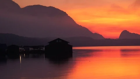Zoom out reflection in water river by the sea , red orange twilight sky backg Stock Footage 89829477