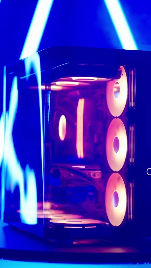 Zoom out RGB gaming computer on turning platform with neon tubes studio shot 4K Stock Footage 324143849