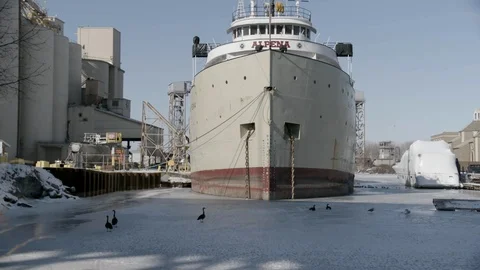 Zoom out Ship moored in dock in Cleveland, OH winter frozen lake Stock Footage 89945019
