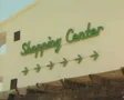 Zoom out from Shopping Center sign to clothing shop SD Footage