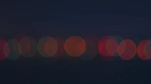 Zoom out shot multicolor round lights in the dark Video stock 99600294