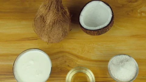 Zoom out shot of tropical coconuts with some coconut products - loopable fruit Stock Footage 130840084