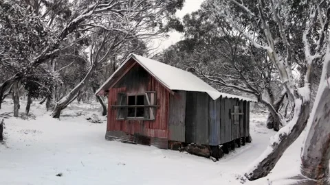 Zoom Out From Snow Covered High Country Alpine Hut Low Aerial 4K Video stock 137553507
