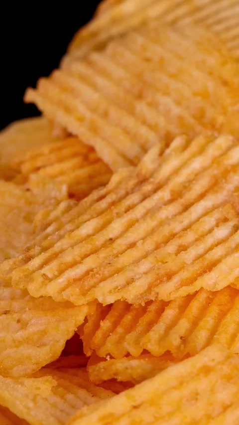 Zoom Out on Stack of Ridged Potato Chips Stock Footage 318940448