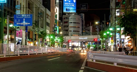 Zoom out street level time lapse looking towards Roppongi crossing at night Stock Footage 49605238