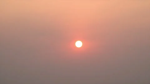 Zoom out from sun at sunset, reflection in water Video stock 50021797