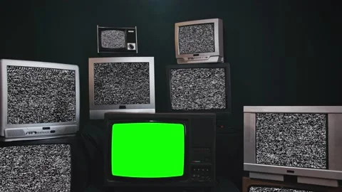 Zoom out then fixed shot in a old tv set with green screen among a wall of retro Vidéo 152297578