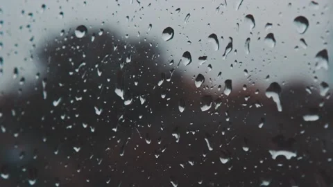 Zoom out time lapse of heavy rain water droplets streaming down on window glass Video stock 163186264