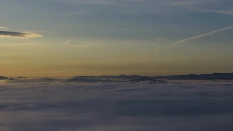 Zoom out time lapse over inversion clouds. Low fog clouds moving over basin Stock Footage 129079321