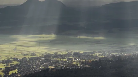 Zoom out time lapse sun rays shine on rural countryside field area while moving Stock Footage 129106460