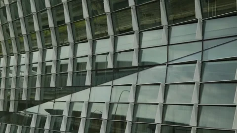 Zoom out Traffic reflected on International Convention Centre windows 4K Video stock 304570746