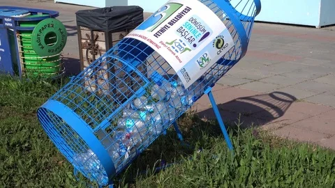 Zoom out trash bin in the shape of a bottle against waterfront Stock Footage 80834974