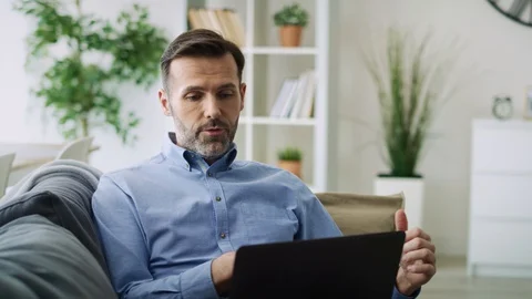 Zoom out video  of man gesturing during a video conference. Stock Footage 128810732