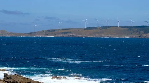 Zoom out view of ocean wind turbines farm, green energy over deep blue sea waves Stock Footage 117107641