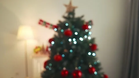 Zoom-out view of shiny red ribbed Christmas bauble with ribbon and fake snow Stock Footage 319010690