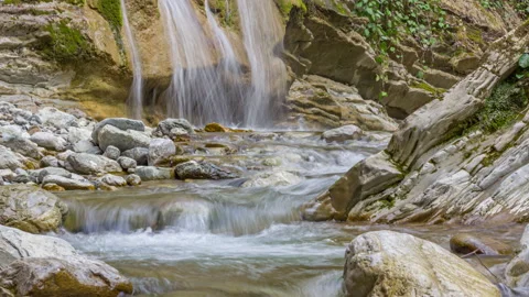 Zoom out view of a waterfall surrounded by stones Stock Footage 150251131