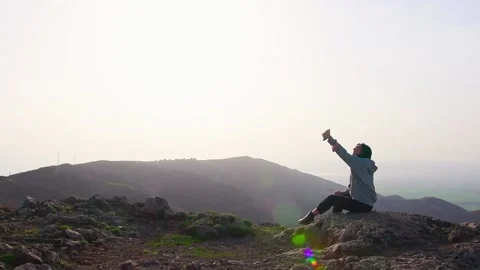 Zoom out view young attractive brunette takes selfie smart phone with scenic  Stock-Footage 152446745
