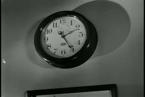 Zoom out wall clock to picture frames on wall Stock Footage 11347115