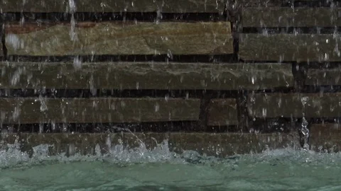 Zoom out water falling down stone work into pool 스톡 동영상 76256823