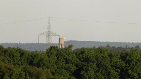 Zoom out: Water tower of small village Morlautern, rural Germany, forest Stock Footage 89556414