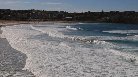 Zoom out from waves at Bondi beach in Sydney with surfers in 4k. Stock Footage 135494923