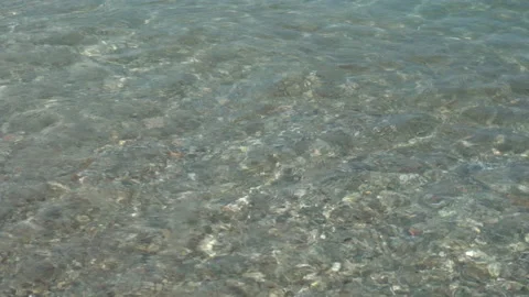 Zoom out from waves hitting the shore to the horizon in Liguria in Italy - 4K Stock Footage 157640348