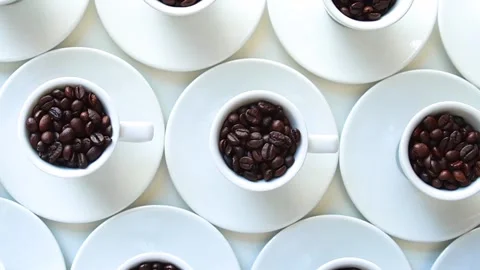 Zoom out of white coffee cup with coffee beans arranged on table,  top  view Stock Footage 281791883