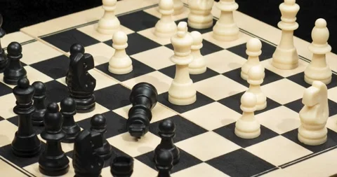 Zoom out of a white king chess piece check mate over a chess board Video stock 328319751