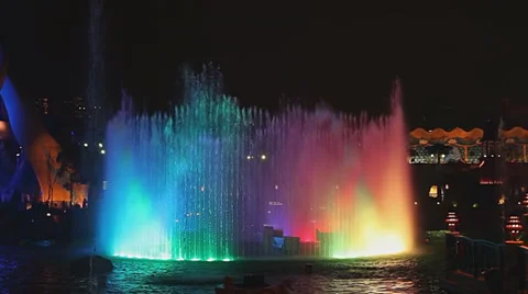 Zoom out wide shot of multicolored fountain Stock Footage 34162772