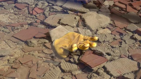Zoom out work glove in water with debris Stock Footage 73607906