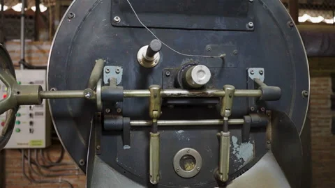 Zoom out on a working coffee roaster, own business or small business. Stock Footage 183392546