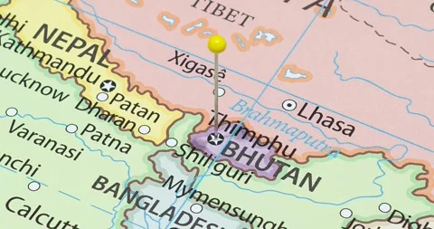 A zoom out of a yellow pin into thimphu city of bhutan political map Stock Footage 325313435