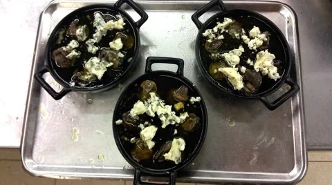 Zoom in on a pan full of Escargots, topped with roquefort cheese Stock Footage 58302842