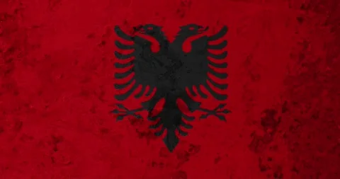 A zoom panning video of a worn out rusty wall with the albania flag Stock Footage 337426871