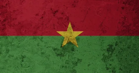 A zoom panning video of a worn out rusty wall with the burkina faso flag Stock Footage 337427222