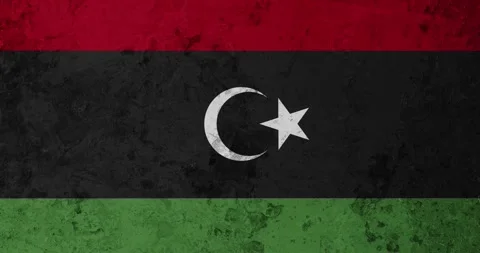 A zoom panning video of a worn out rusty wall with the libya flag Video stock 337429635