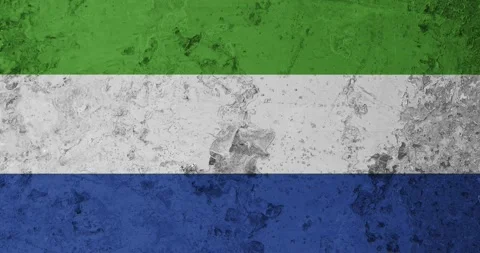 A zoom panning video of a worn out rusty wall with the sierra leone flag Video stock 337431361