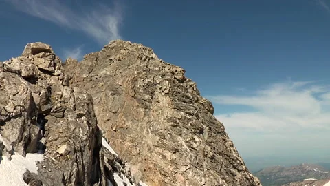 Zoom in to Rock Face to Reveal Two Mountaineers Stock Footage 197979189