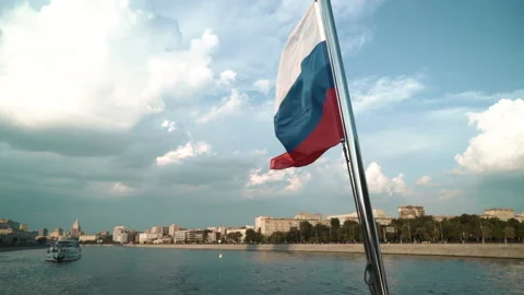 Zoom in Russian flag waving in the background of the cityscape, slowmotion Stock Footage 212388937