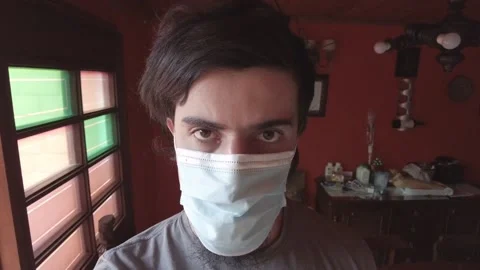 Zoom in scene of a hispanic or latin young man with a medical face mask Vídeo Stock 147570855