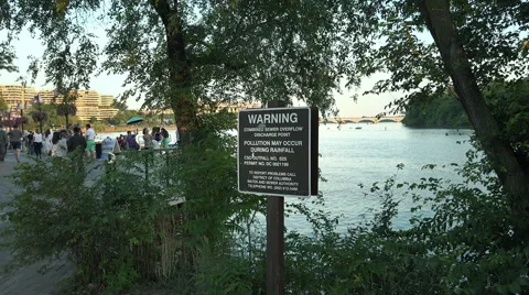 Zoom in Sewer Overflow warning sign, Potomac River, DC, stock footage 動画素材 40385634