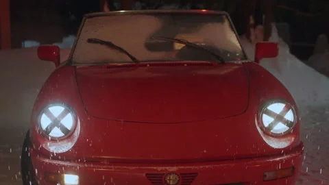 Zoom in shining front car headlights of red Alfa Romeo Spider, snow falling Stock-Footage 197455264