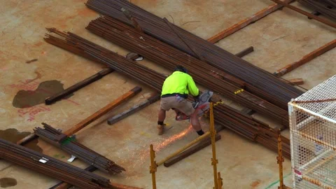 Zoom in shot capturing a structural steel erector or ironworker using Stock Footage 242973131