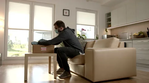 Zoom-In Shot Of A Cardboard Box Laying On a Table In a Open Plan Living Room Stock Footage 140258564