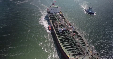 Zoom in shot of a of a Cargo ship &amp; a Pilot Boat shot in 4K Stock Footage 182892162