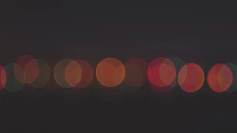 Zoom in shot chain of bright multicolored round lights garlands in the dark Stock Footage 99600191