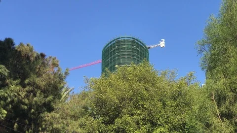 Zoom In Shot of Construction Site Crane Turning above a Skyscraper in Nicosia Stock Footage 100982286