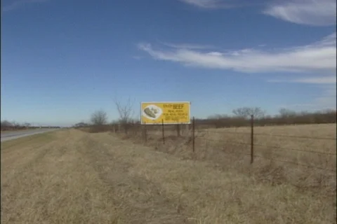 Zoom Shot of Enjoy Beef Billboard on Roadside Stock Footage 121606384